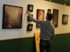 Dennis hanging his artwork