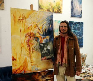 Leo Plaw in his studio with the book Imagine the Imagination